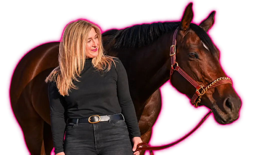 Cat Allen standing beside her mare Unbridled Dixie, smiling.