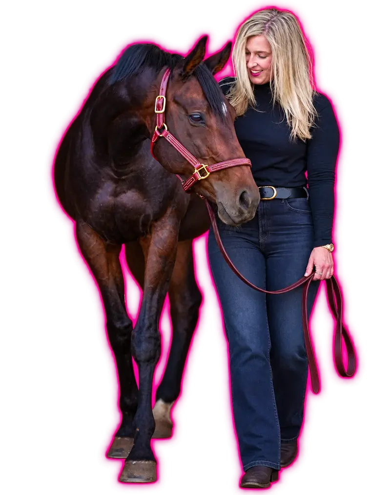 Cat Allen walking beside her mare Unbridled Dixie, looking at her.